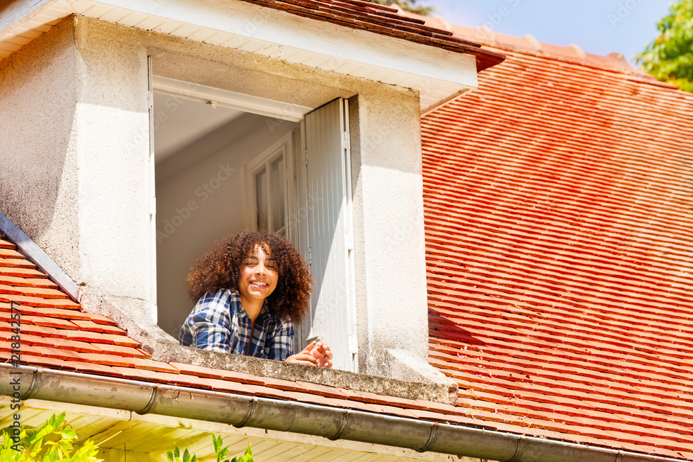 African girl enjoying morning in the open window