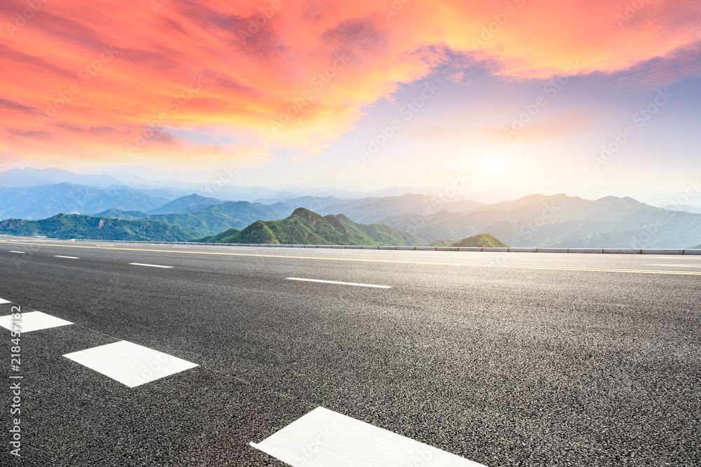 Asphalt highway and mountain natural landscape at sunrise