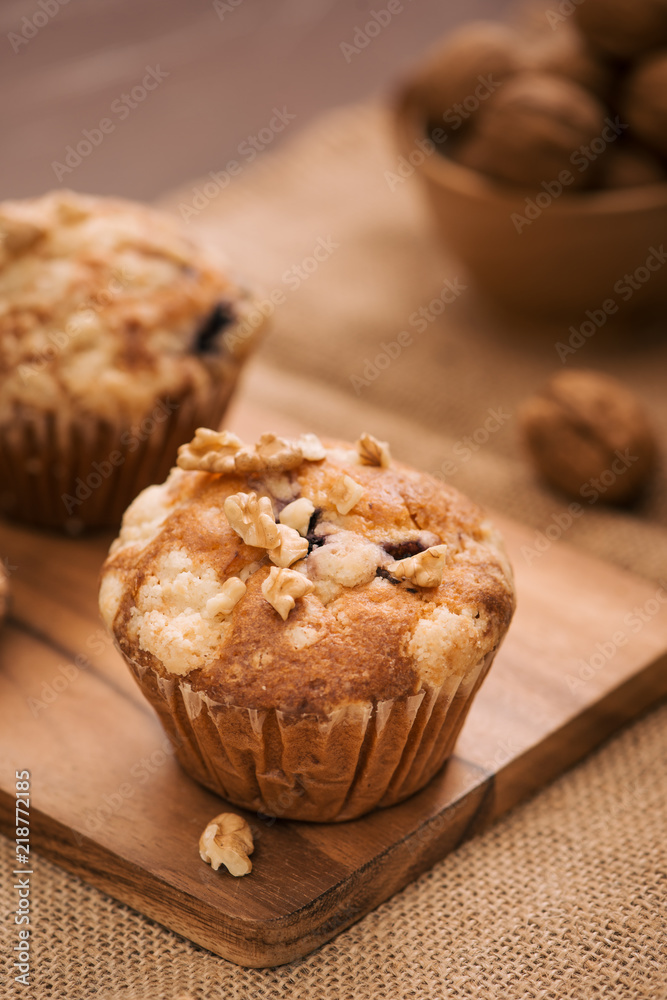 Tasty homemade walnut muffins on table. Sweet pastries