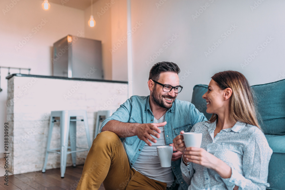 Couple drinking coffee at home.