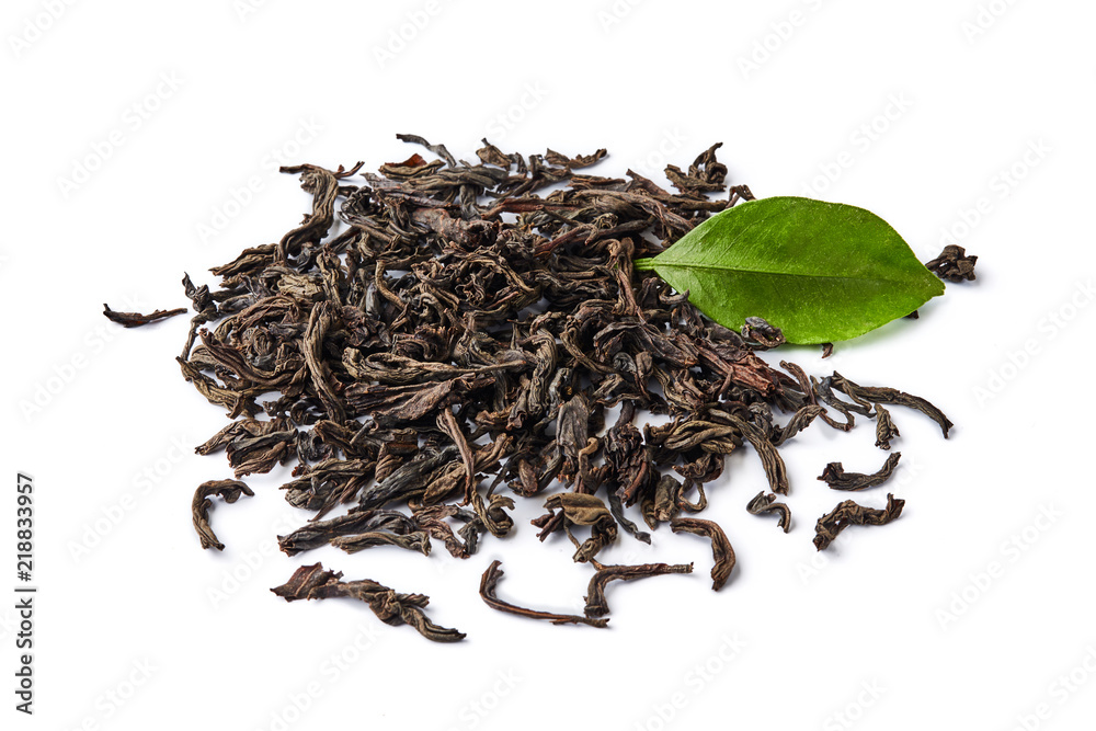 Heap of dried black tea leaves isolated on white background.