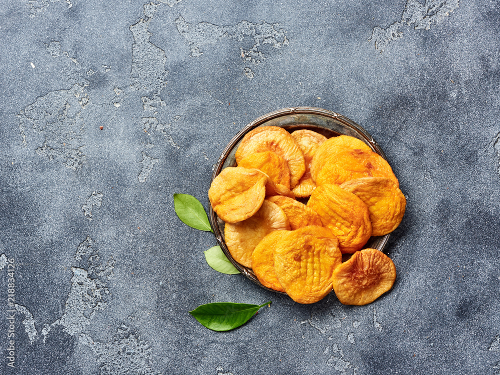 Dried apricots on gray background. Top view.