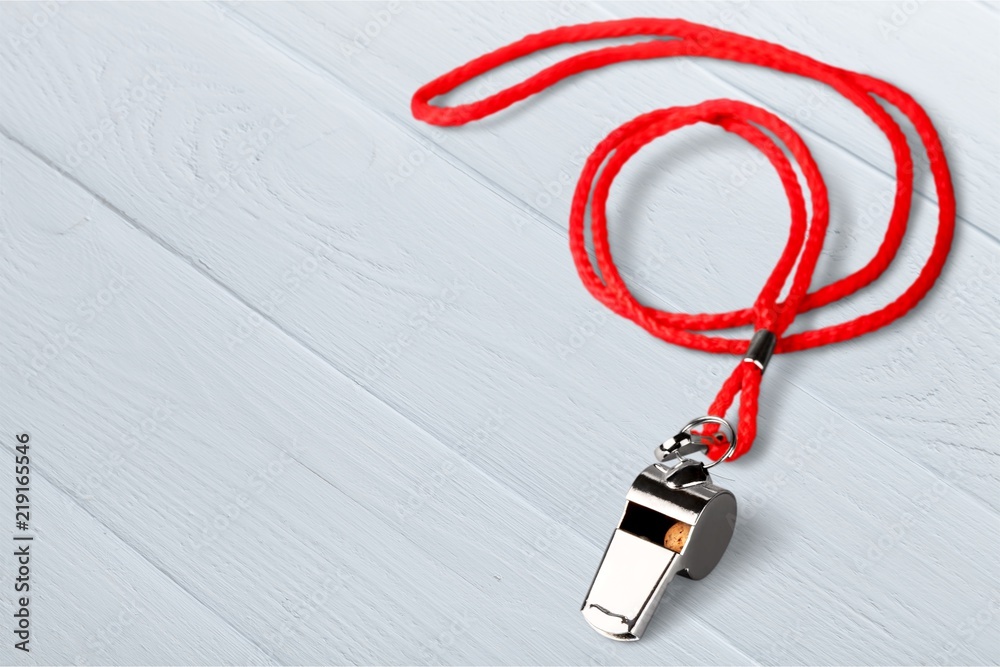 Sports whistle with a lace. It is isolated on a white background