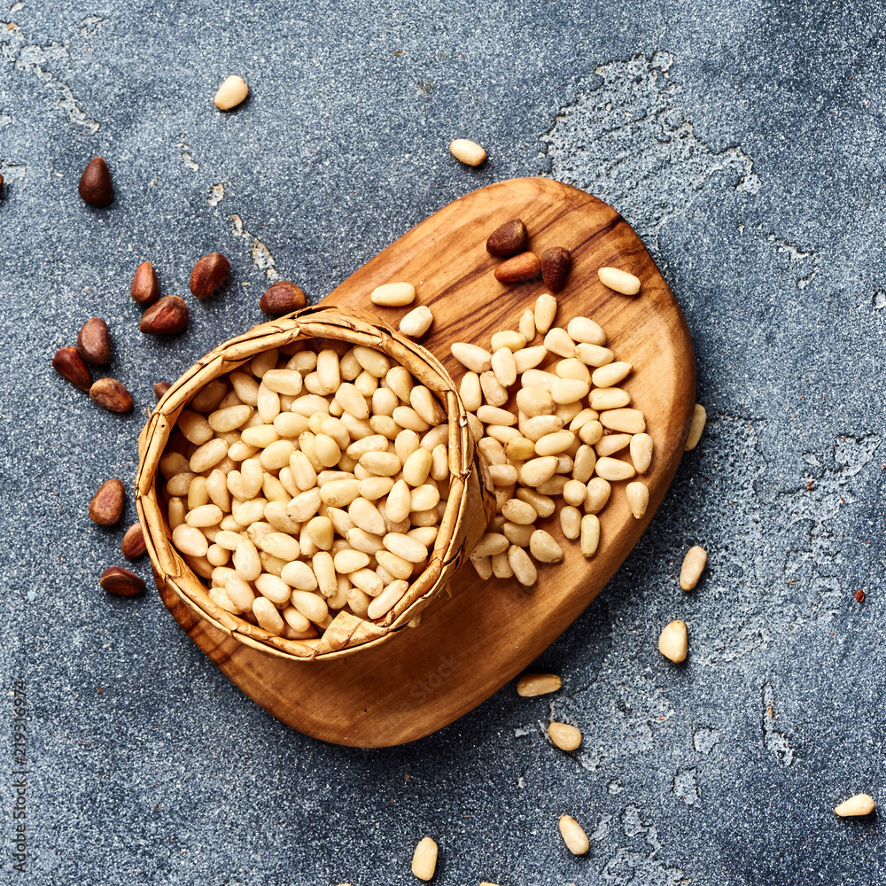 Peeled pine nuts on gray background. Top view.