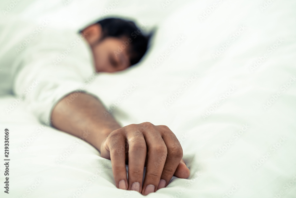 Young man sleep in bed in the bedroom.