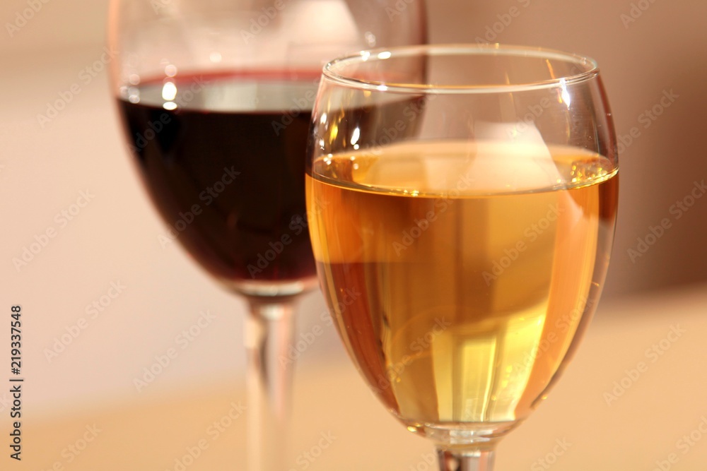 A glass of white wine and a glass of red wine