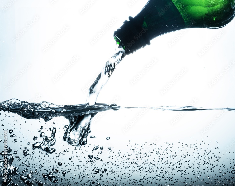 Water Pouring out of Plastic Bottle on the Grey background