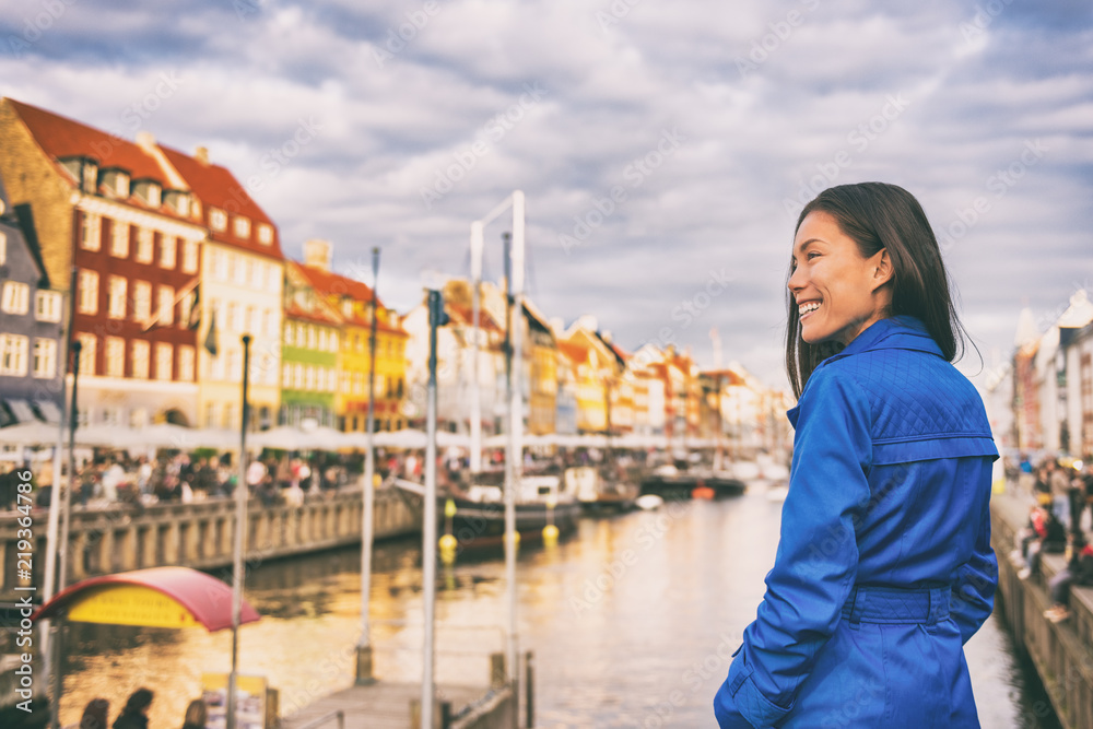 Tourist in Copenhagen. Chinese Asian woman traveler walking in Nyhavn visiting Denmark. City travel,