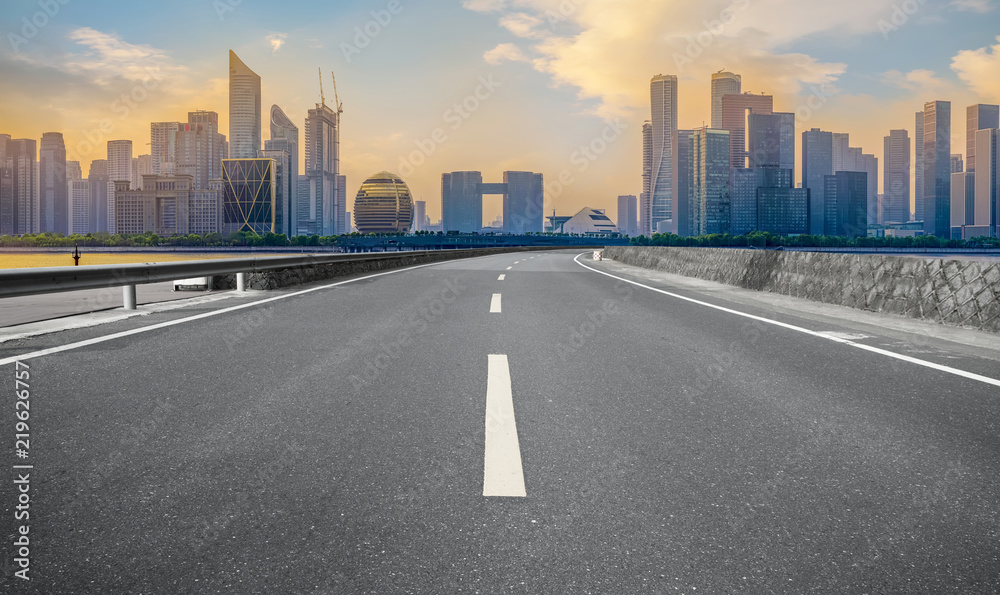 Urban road asphalt pavement and skyline of Hangzhou architectural landscape