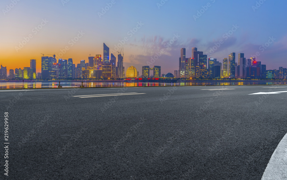 Urban road asphalt pavement and skyline of Hangzhou architectural landscape