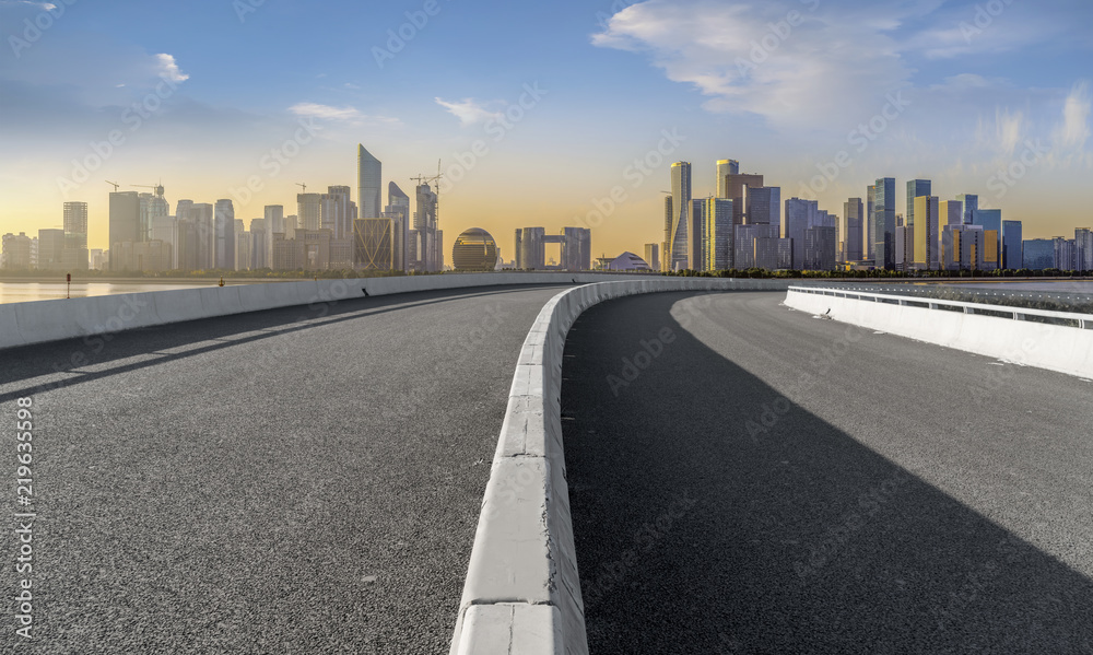 Urban road asphalt pavement and skyline of Hangzhou architectural landscape