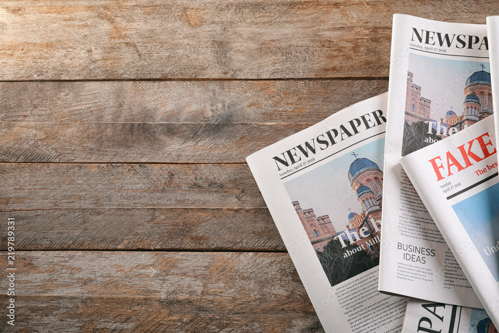 Newspapers on wooden background