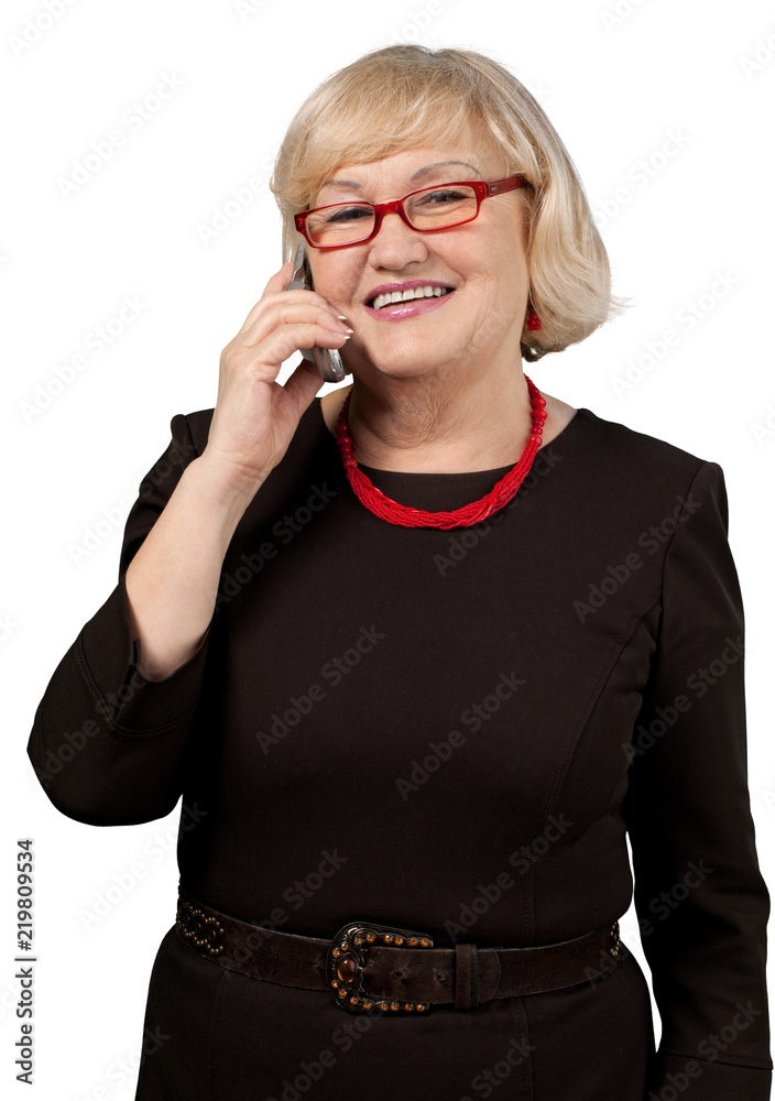 Mature businesswoman talking on phone isolated on white