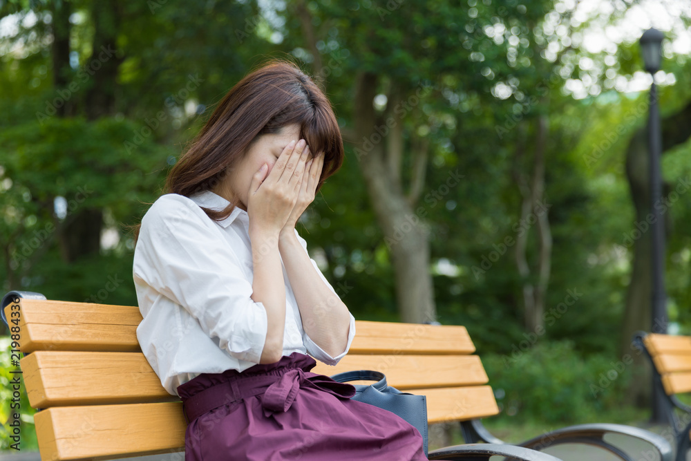 young asian woman sitting bench in park