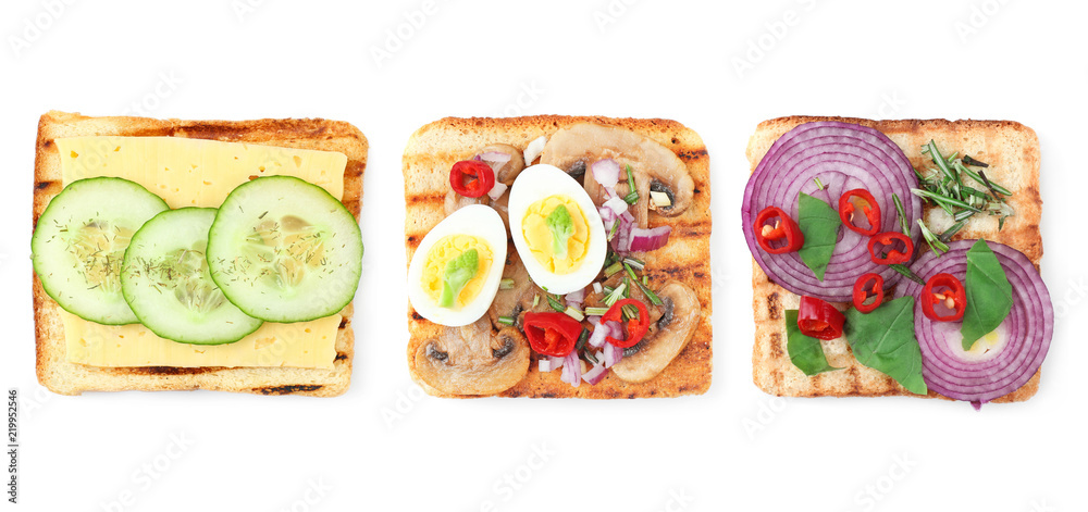 Different delicious toasts with vegetables on white background