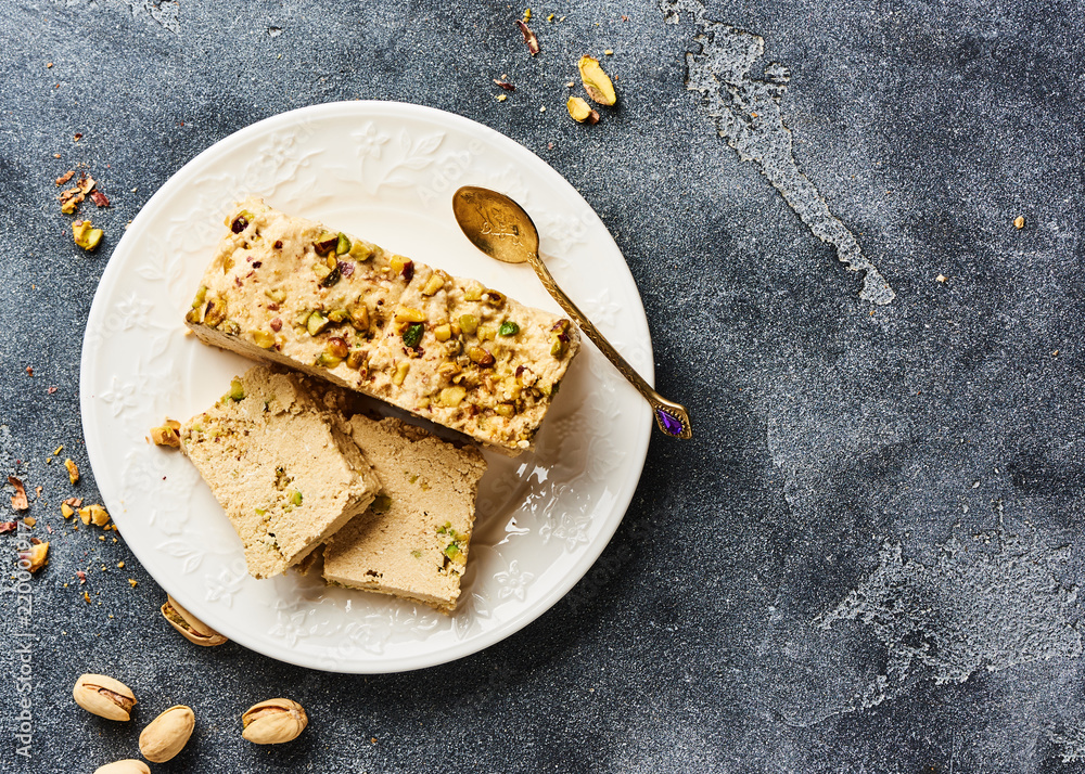 Homemade organic sesame halva. Top view of nut dessert with pistachios.