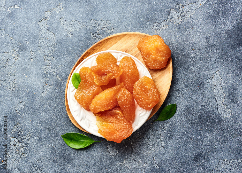 Candied sliced pear. Dried fruits on gray background. Top view.