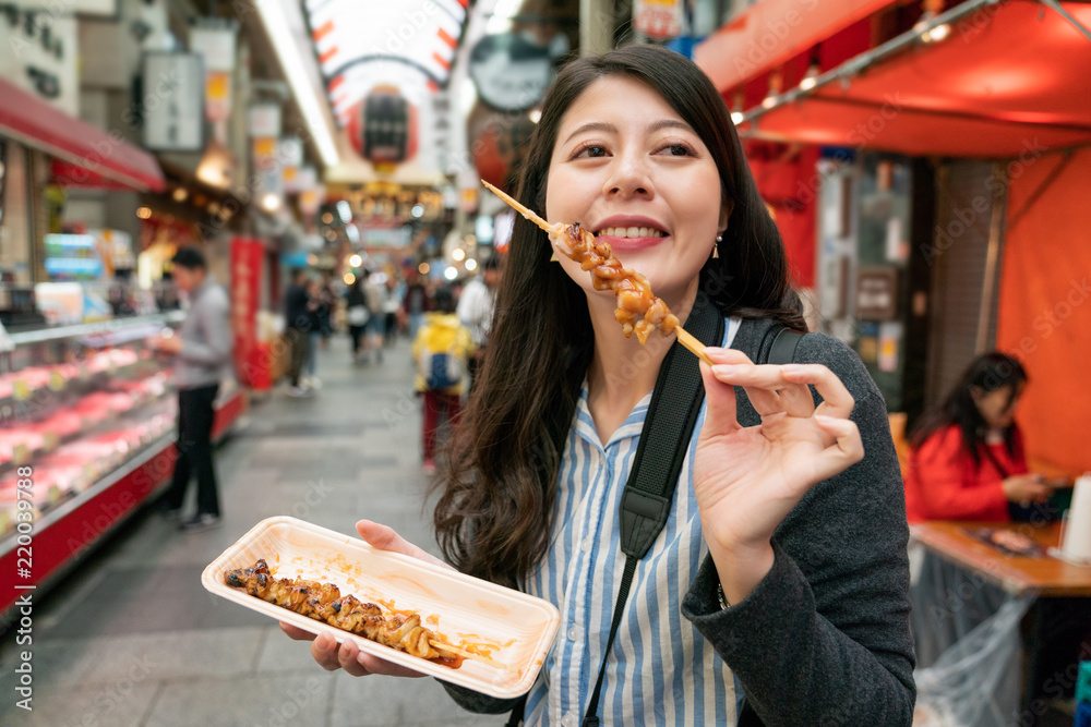 Pretty woman enjoying the street food.