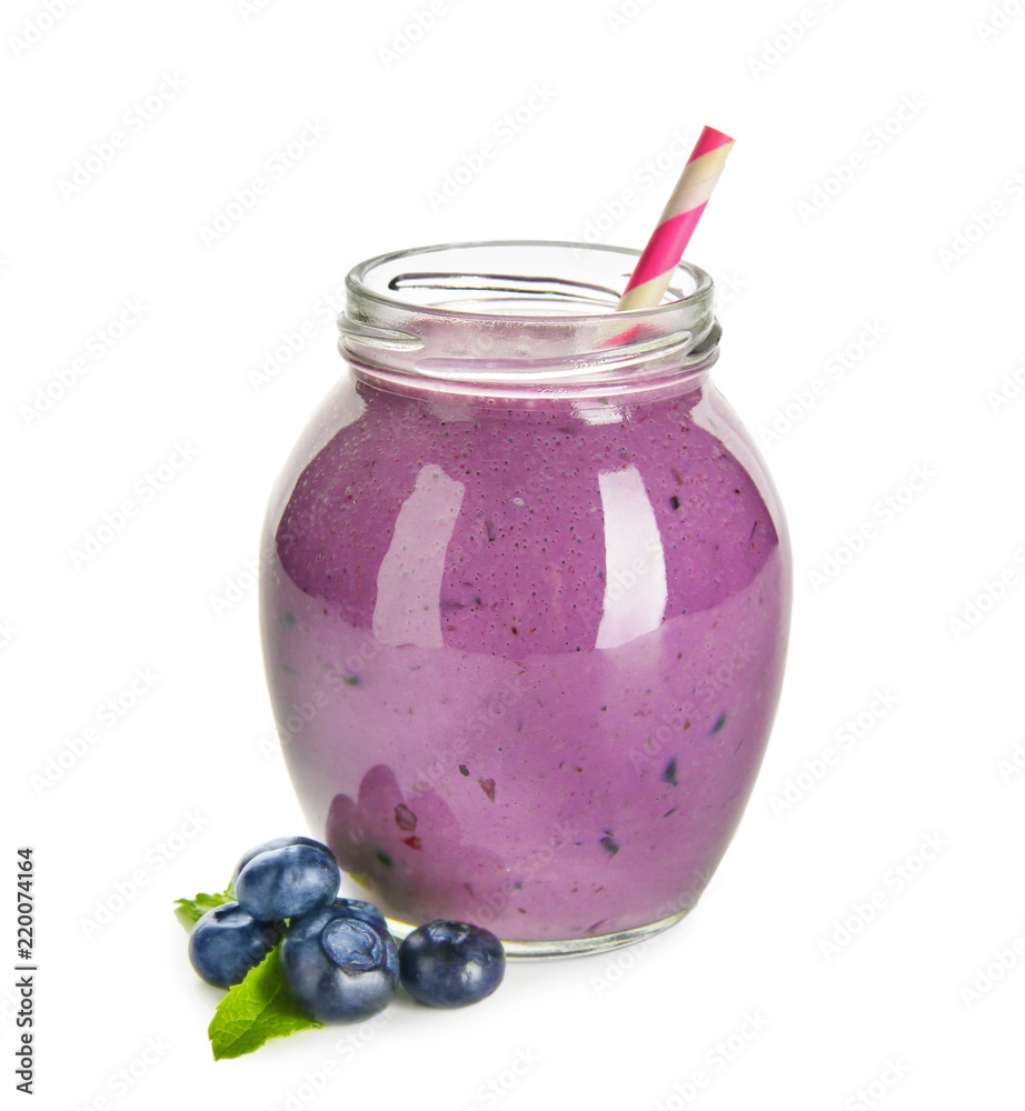 Glass jar of tasty blueberry smoothie on white background