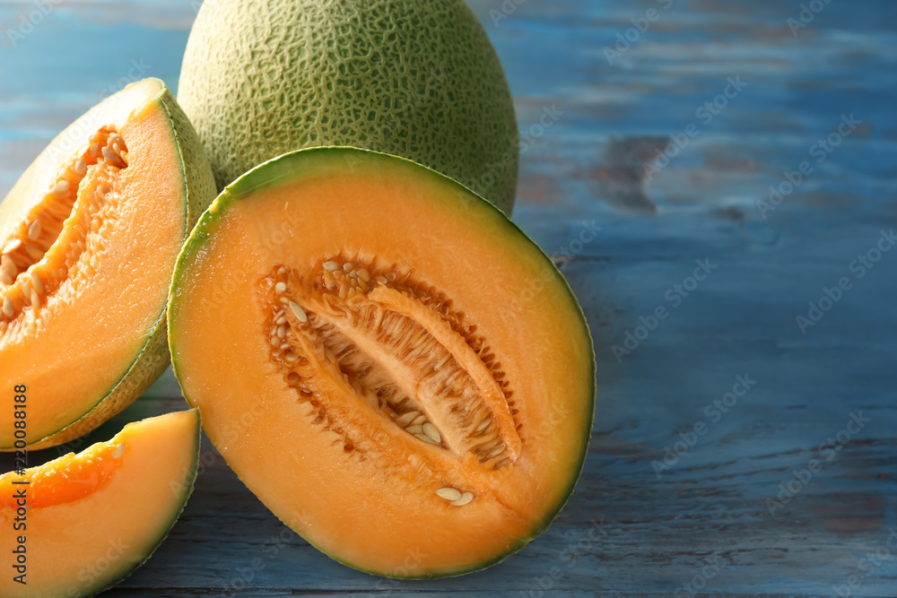 Cut ripe melons on wooden table