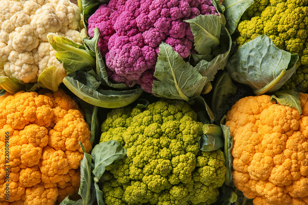 Colorful cauliflowers on table, top view