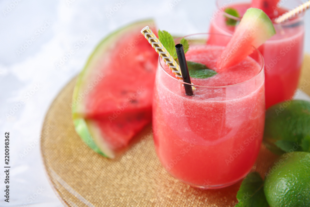 Glass with fresh watermelon smoothie on table