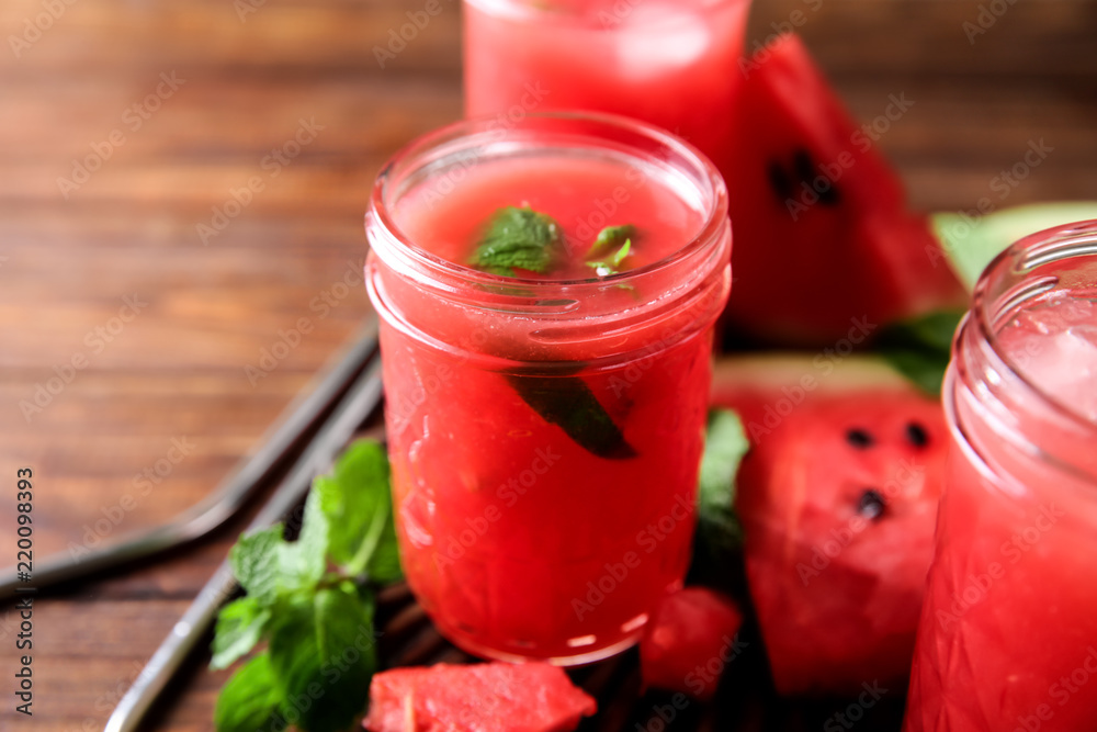 Jar with fresh watermelon smoothie on table