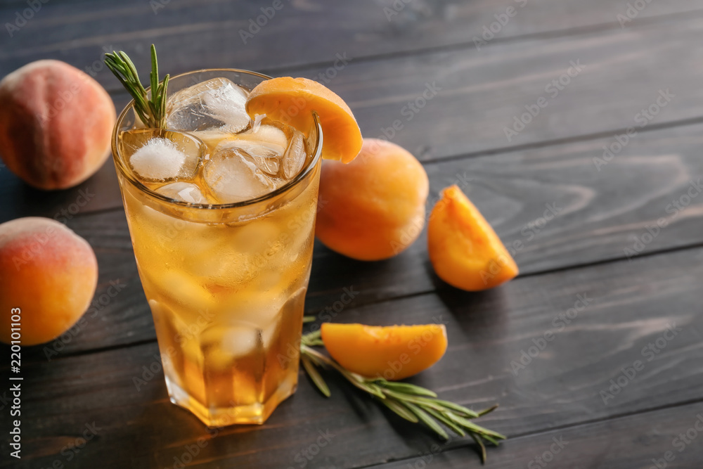 Peach cocktail in glass on wooden table