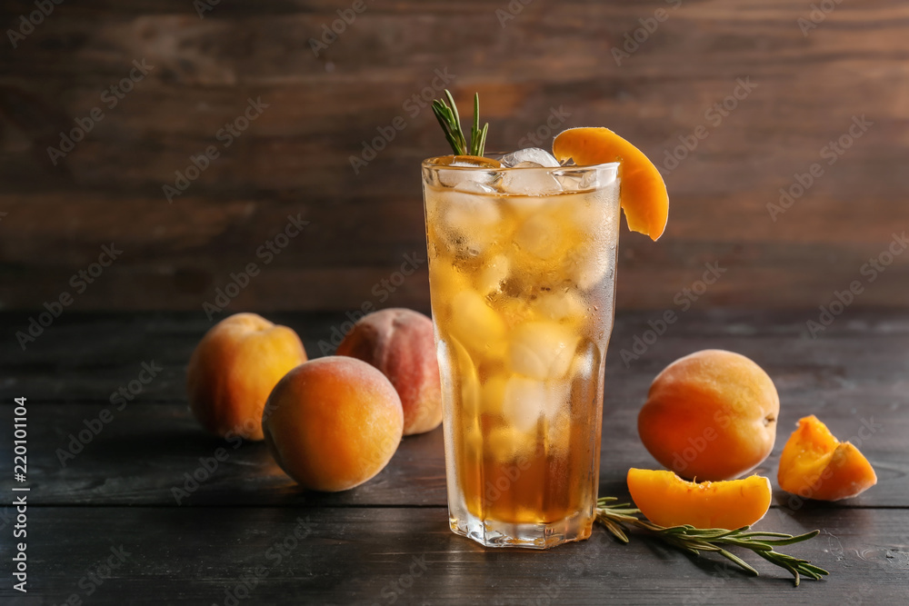 Peach cocktail in glass on wooden table