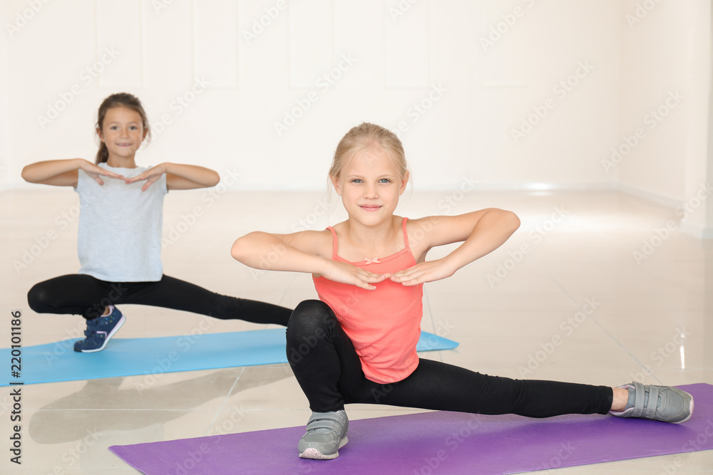 Little girls practicing yoga indoors