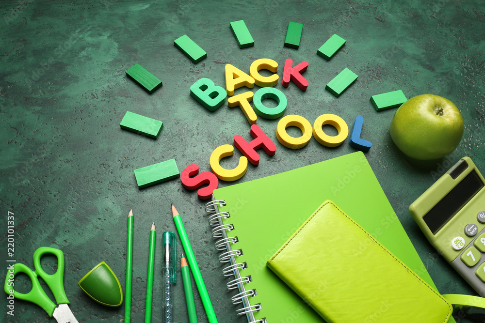 Phrase BACK TO SCHOOL made with letters and stationery on color background