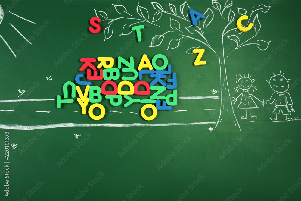 Creative composition with letters and drawings on chalkboard