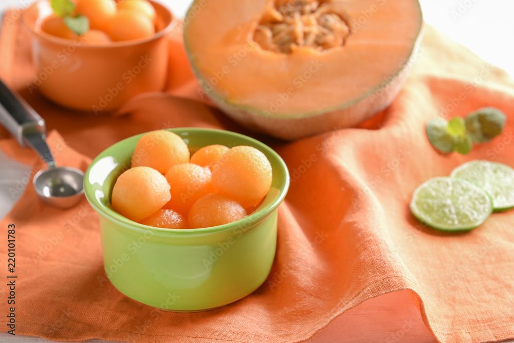 Bowl with tasty melon balls on table