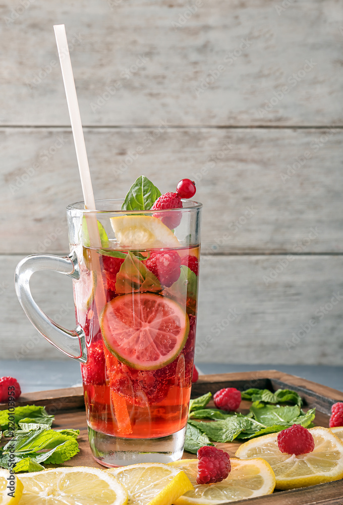 Glass of fresh raspberry lemonade on board