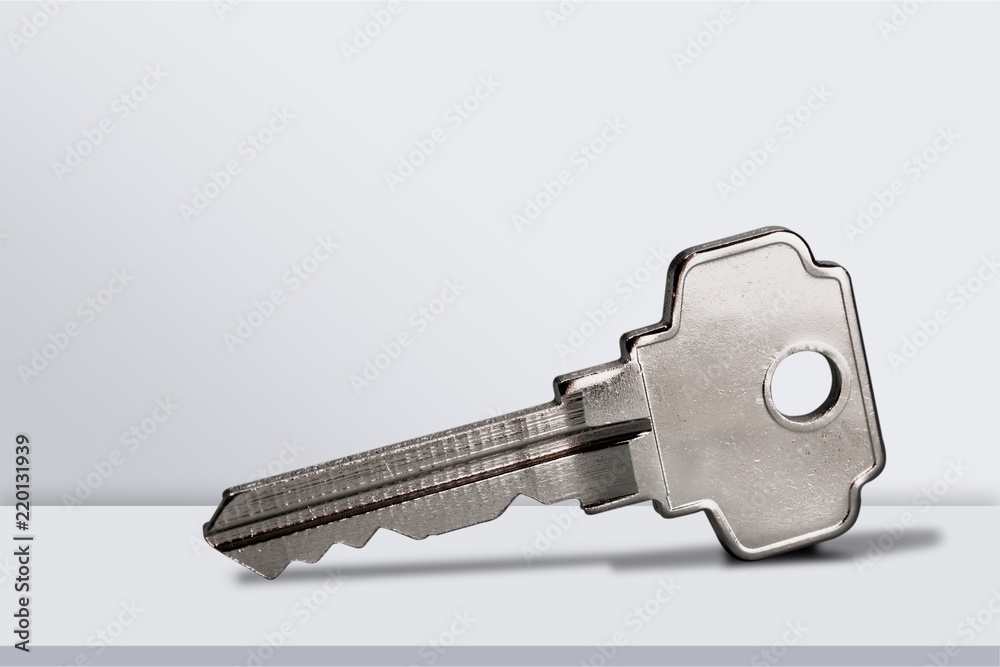 House keys with trinket on wooden background