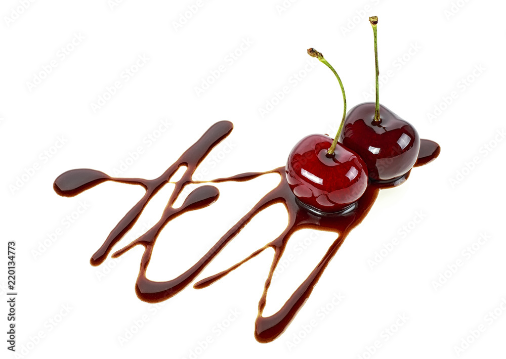 Two ripe cherries in chocolate on a white background