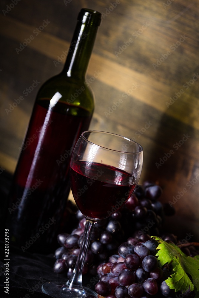 Wine Glass, Wine Bottle And Red Grape Clusters