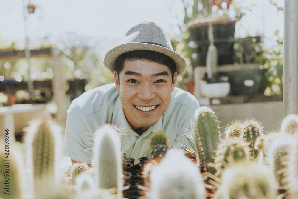 Cheerful man buying a cactus