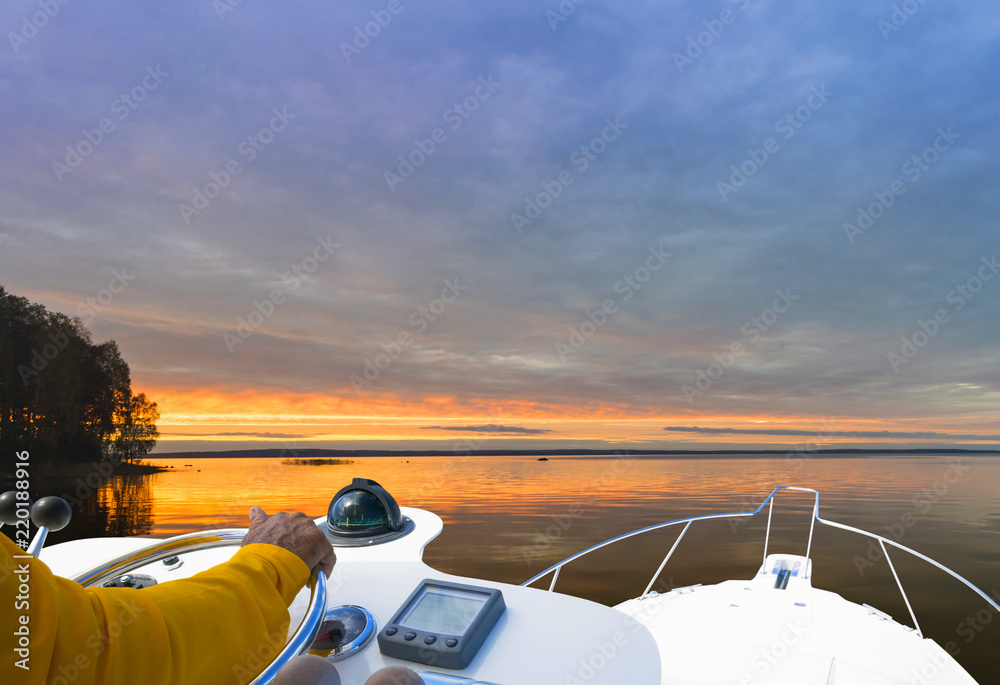 Hand of captain on steering wheel of motor boat in the blue ocean during the fishery day. Success fi