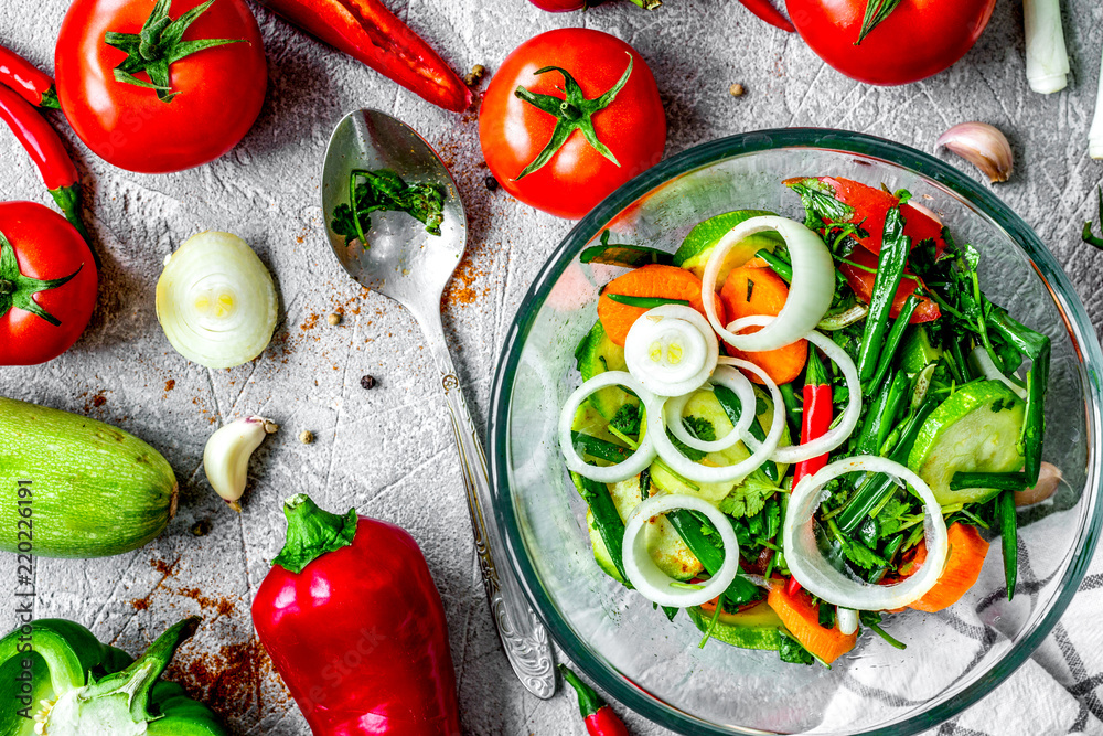 cooking vegetables on the stone background top view