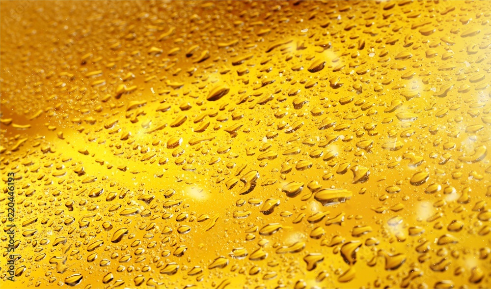 Close up shot of yellow beer bubbles on white background