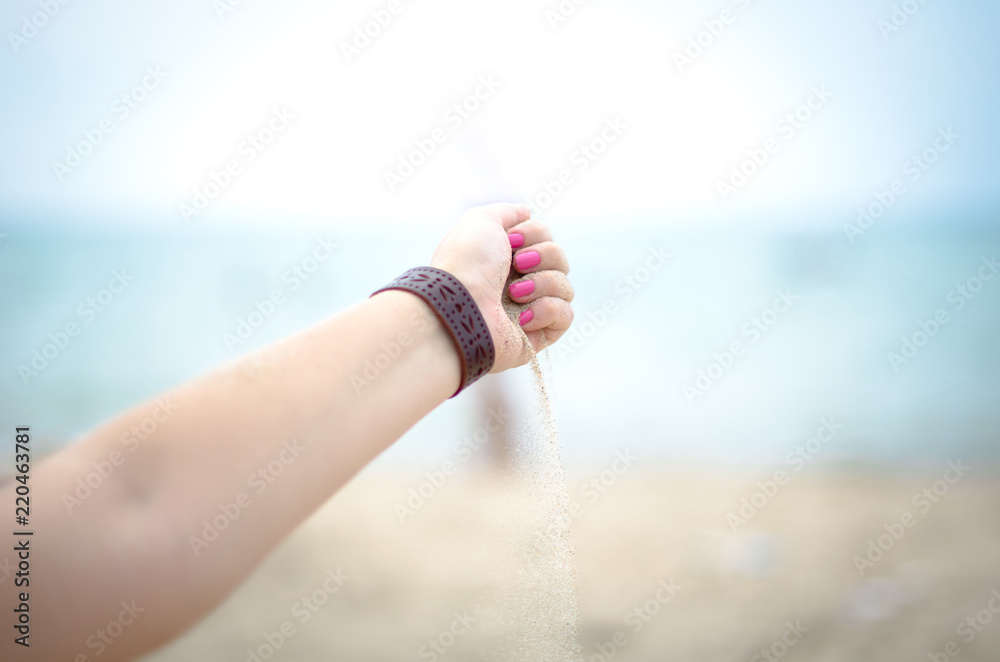 The sand running through the fingers