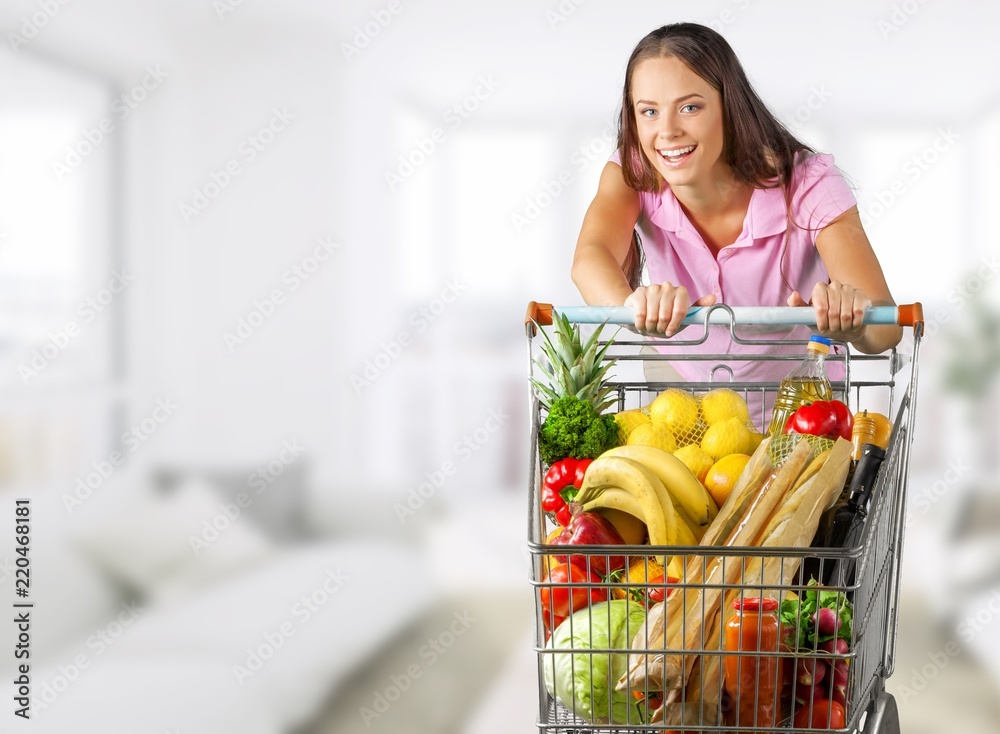 Woman with cart shopping in supermarket