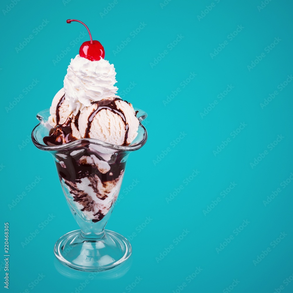 Delicious ice cream dessert with whipped cream and cherry