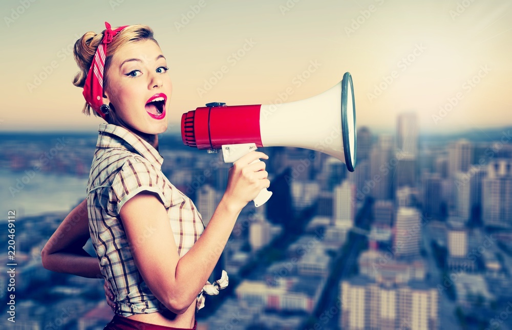 Portrait of woman holding megaphone, dressed in pin-up style