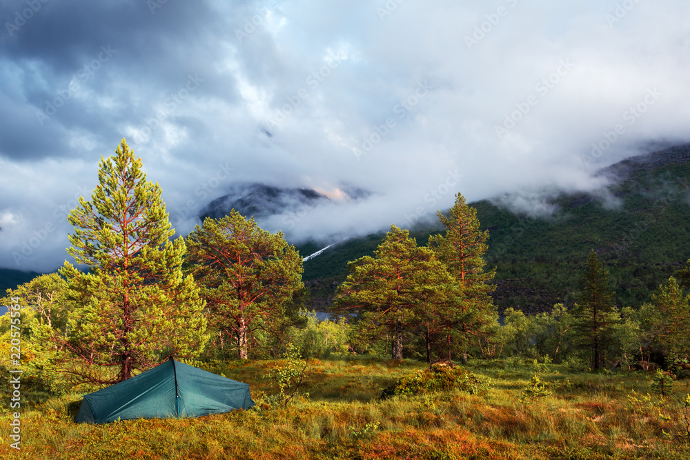 Mountain peak in fog in Innerdalen - Norways most beautiful valley, near Innerdalsvatna lake. Norwa