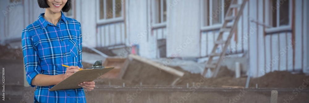 Composite image of female architect writing on clipboard against