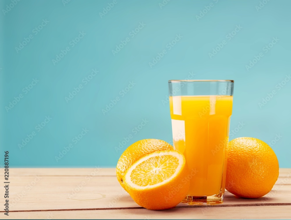 Orange juice and slices of orange on background