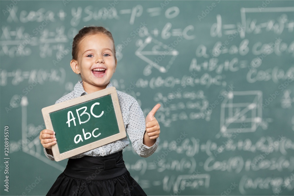 Cute little girl with  books on  background