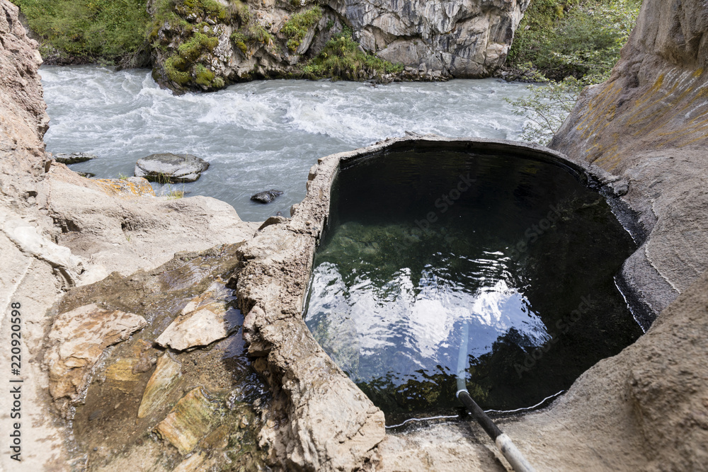 Small hot springs in the valley of Altyn-Arashan in Kyrgyzstan. The water is collected in small pool